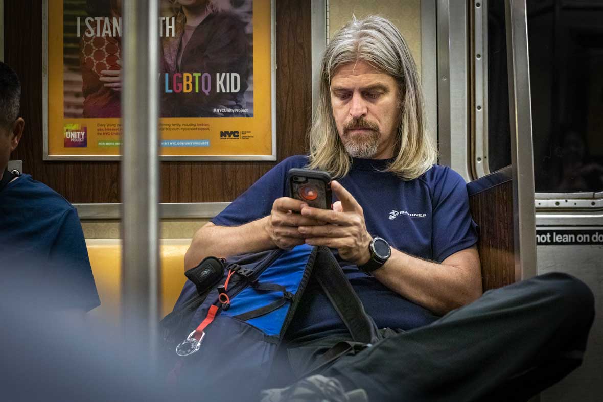 Man using iPhone on New York City Subway NYC | Lifestyle and Branding Photographer | Pamela Kay Photography | Branding Copywriter SEO Marketing